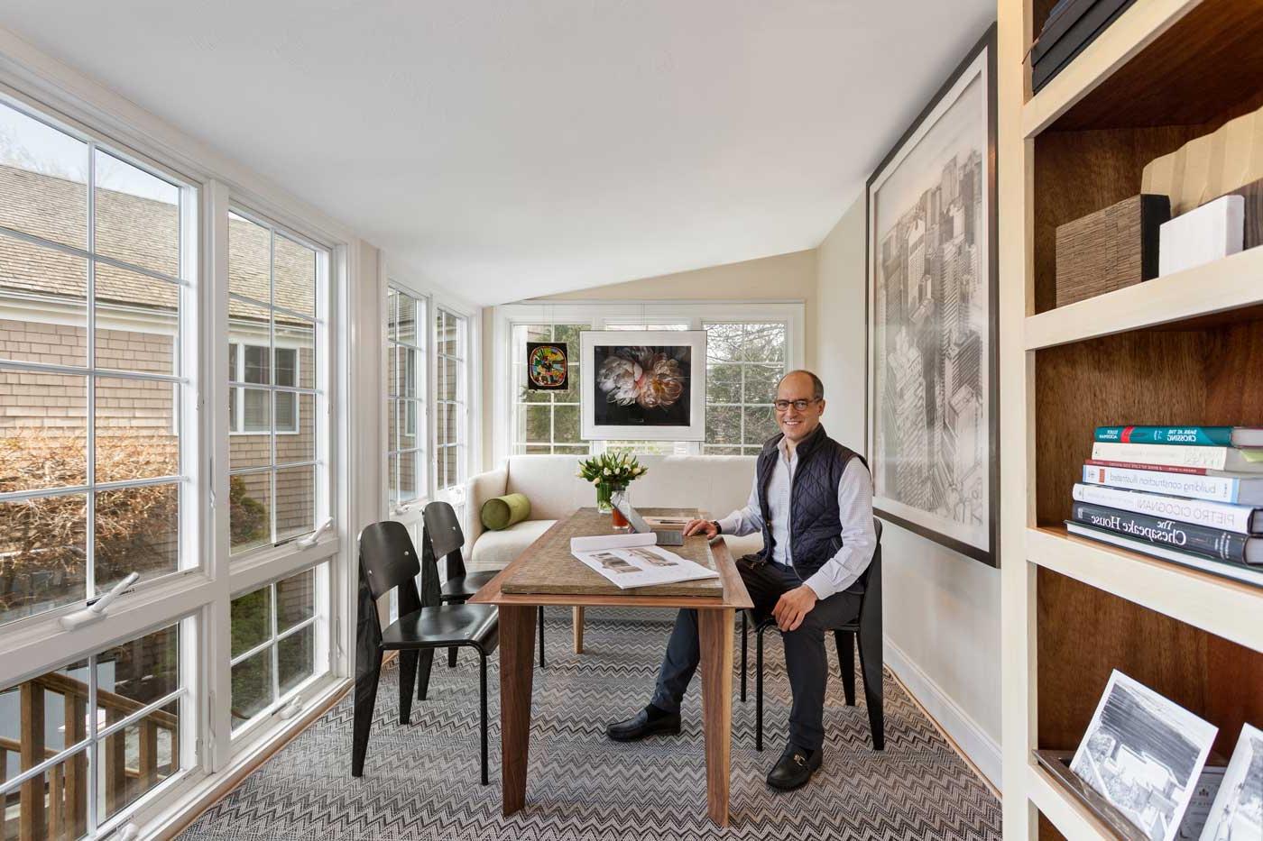 Nick Stanos sitting at a desk in his office