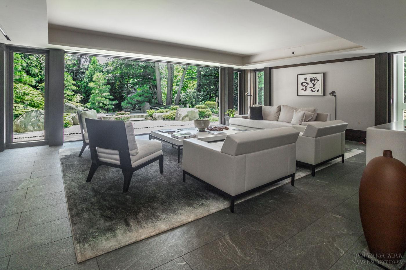 Serene living area with floor to ceiling windows looking out into nature